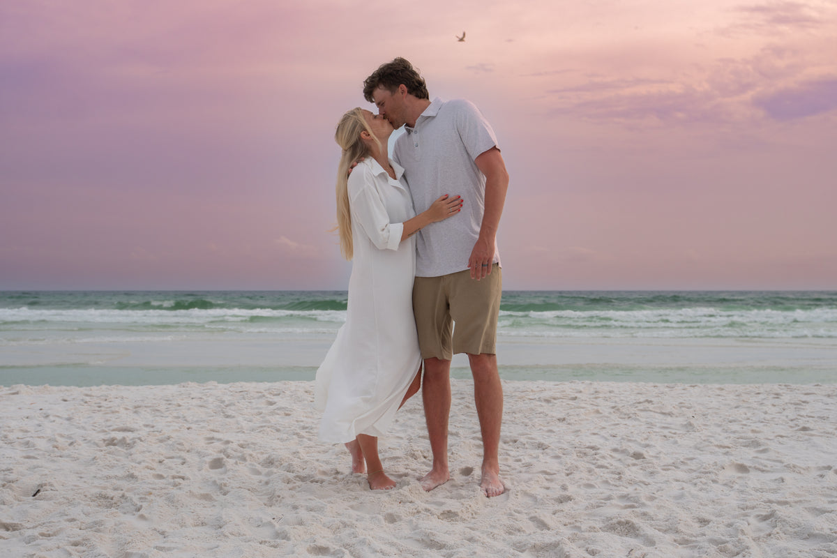 Couple kissing on the beach at sunset on 30A