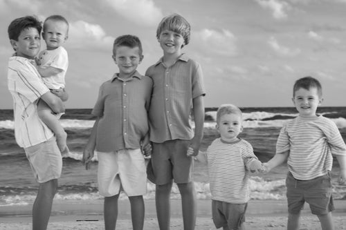 Black and white photo of kids on the beach